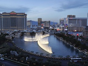 FILE - In this April 4, 2017, file photo, the fountains of Bellagio erupt along the Las Vegas Strip in Las Vegas. Tens of thousands of casino workers in Las Vegas whose contracts expire next week were preparing to vote on Tuesday, May 22, 2018, on whether to authorize a strike, a move that could leave more than 30 properties without unionized housekeepers, bartenders, servers and other key employees.