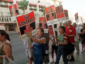 FILE - In this June 30, 2002 file photo, members of the Culinary Union Local 226 picket outside the Plaza hotel-casino in Las Vegas hours before their contract was to expire. Fifty-thousand unionized Las Vegas casino workers whose contracts will expire at the end of the month are set to vote on whether to go on strike. The Culinary Union on Wednesday, May 9, 2018, said it will hold a strike vote May 22 at a university arena.