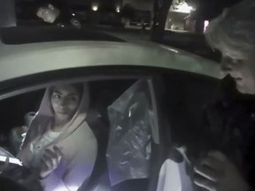 FILE - In this April 3, 2018 file image from video provided by the Mountain View Police Department, Nasim Aghdam is questioned by officers after being found asleep in her car in Mountain View, Calif. Aghdam, who shot and wounded three people before killing herself at YouTube headquarters scoped out the California campus a day before striding into its courtyard and shooting indiscriminately into a crowd of employees eating lunch, authorities said Thursday, May 31. (Mountain View Police Department via AP, File)