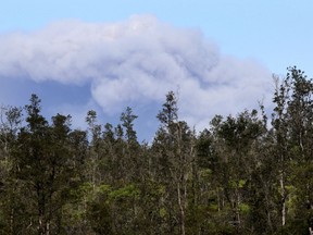An ash plume rises over the summit of Kiluaea volcano, center, as seen from Pahoa, Hawaii, Tuesday, May 15, 2018.