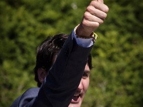Prime Minister Justin Trudeau gsteures to supporters following an infrastructure announcement in Calgary, Alta., Tuesday, May 15, 2018.THE CANADIAN PRESS/Jeff McIntosh