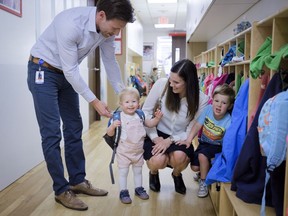 Suncor employees Jenna Pickering, and her husband Shea, pick up their children, Hannah and Luke from the Suncor daycare in Calgary, Alta., Friday, May 25, 2018.THE CANADIAN PRESS/Jeff McIntosh