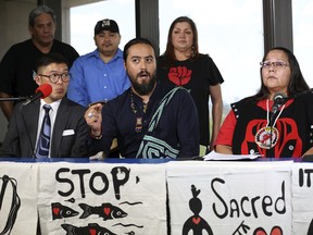 Dr. Tane Ward, center, talks with reporters during a press conference at the Houston Public Library following an appearance at Kinder Morgan International's Annual General Meeting Wednesday, May 9, 2018, in Houston. Ward and Neskonlith te Secwepemc chief Judy Wilson, right, talked about their opposition to the Trans Mountain Pipeline.