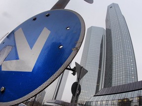 FILE - In this Thursday, Feb, 2, 2017 file photo, a traffic sign stands near to the headquarters of Deutsche Bank ahead of the bank's annual press conference in Frankfurt, Germany. Germany's struggling Deutsche Bank says it's slashing thousands of jobs as it reshapes its stocks trading business and tries to limit costs. The bank said Thursday, May 24, 2018 it would cut its workforce from 97,000 to "well below" 90,000.
