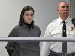 FILE - In this Jan. 22, 2013, file photo, Sonja Farak, left, stands during her arraignment at Eastern Hampshire District Court in Belchertown, Mass. The Massachusetts Supreme Judicial Court will hear arguments on Tuesday, May 8, 2018, that thousands more cases be thrown out which were potentially tainted by misconduct of former chemist Farak. Authorities have said Farak was high almost every day she worked at a state drug lab for eight years.
