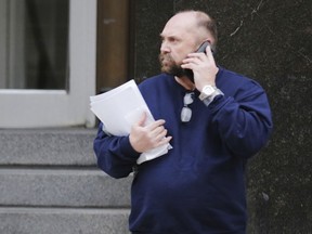 FILE - In this Feb. 2, 2016, file photo, Arthur Rathburn of Grosse Pointe Park, Mich., walks out of Theodore Levin United States Courthouse in Detroit. Prosecutors are seeking a 14-year prison sentence for Rathburn convicted of dealing diseased body parts for medical training. He is returning to Detroit federal court on Monday, May 21, 2018, four months after he was convicted of fraud and shipping hazardous material.