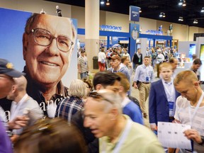 An image of Warren Buffett is seen above Berkshire Hathaway shareholders on the exhibit floor at the CenturyLink Center in Omaha, Neb., Friday, May 4, 2018, where Berkshire brands display their products and services. On Saturday, shareholders are expected to fill the CenturyLink arena as they attend the annual Berkshire Hathaway shareholders meeting where Buffett and his Vice Chairman Charlie Munger preside over a Q&A session.
