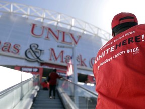 Culinary Union members file into a university arena to vote on whether to authorize a strike Tuesday, May 22, 2018, in Las Vegas.  A potential strike would affect 34 casino-hotels. A majority yes vote would not immediately affect the casinos, but it would give union negotiators a huge bargaining chip by allowing them to call for a strike at any time starting June 1.