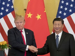 FILE - In this Nov. 9, 2017 file photo, President Donald Trump and Chinese President Xi Jinping shake hands during a joint statement to members of the media Great Hall of the People in Beijing, China. The U.S. is announcing that it will impose a 25 percent tariff on $50 billion worth of Chinese goods containing "industrially significant technology." The White House said Tuesday, May 29, 2018,  that the tariff will cover goods related to the "Made in China 2025" program. The full list of imports that will be covered will be announced by June 15.