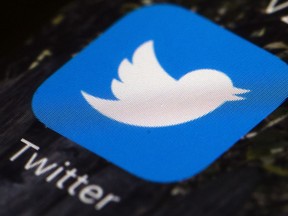 FILE- This April 26, 2017, file photo shows the Twitter icon on a mobile phone, in Philadelphia.  Twitter says it discovered a bug that stored passwords in an internal log in an unprotected form. Though Twitter says there's no indication of any breach or misuse of passwords, the company is recommending a change as a precaution