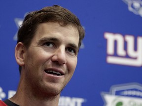 FILE - In an April 25, 2018 file photo, New York Giants quarterback Eli Manning speaks to reporters during NFL football training camp, in East Rutherford, N.J. Jury selection is scheduled to begin on Monday, May 14, 2018, in a New Jersey memorabilia dealer's lawsuit that accuses New York Giants quarterback Eli Manning of conspiring with the team's equipment staff to sell bogus "game-used" helmets to unsuspecting collectors as part of a long-running scam.