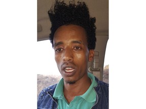 In this March 26, 2018 photo, worker Ebissa Gari speaks just outside Huajian's new industrial park, about working conditions in the Huajian factory in the outskirts of Addis Ababa, Ethiopia. "If someone complains, he will be accused of disturbing the workplace and will be fired right away," said Gari, a 22-year-old who estimated he earns 960 Birr ($35) a month. "That's why we keep quiet and work no matter how much we are subdued."