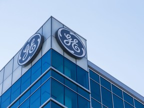 FILE- In this Jan. 16, 2018, file photo, the General Electric logo is displayed at the top of their Global Operations Center in the Banks development of downtown Cincinnati. General Electric is joining with Wabtec Corp. in a cash-and-stock deal as part of a move to help bolster its transportation unit.
