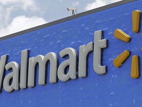 FILE - This June 1, 2017, file photo, shows a Walmart sign at a store in Hialeah Gardens, Fla. Walmart says it will pay about $16 billion for a majority stake in India's leading e-commerce company Flipkart, giving the world's largest retailer a formidable presence in a fast-growing economy.