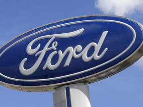 FILE - This Jan. 17, 2017, file photo shows a Ford sign at an auto dealership, in Hialeah, Fla. There's no apparent signs that Wall Street is worried about a plant fire that is forcing Ford to cut back on production of its F-150 pickup, the top-selling vehicle in America. The company suspended F-150 and Super Duty production in several cities.