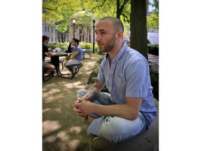 In this May 9, 2018 photo, Iraq War veteran Kristofer Goldsmith, sits in a campus park after his last final exam of the semester at Columbia University in New York. Military veterans with less-than-honorable discharges from the military say they often can't get jobs, and they hope a recent warning to employers by the state of Connecticut will change that. Goldsmith says that for veterans with bad paper, their service record looks more like a criminal record to potential employers.