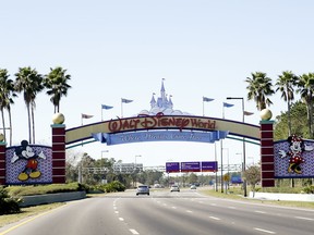 FILE- In this Jan. 31, 2017, file photo, cars travel one of the roads leading to Walt Disney World in Lake Buena Vista, Fla. A regional director of the National Labor Relations Board last week ruled that about 60 drivers who pick up Disney World guests using the Lyft app can be represented by the Teamsters local in Orlando. The Lyft drivers are Disney World employees who earn extra money by driving guests around the resort that is roughly the size of the city of San Francisco.