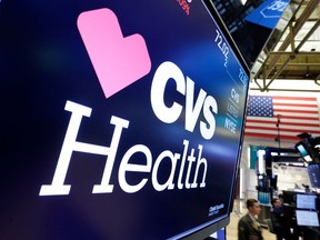 FILE- In this Dec. 4, 2017, file photo, the CVS Health logo appears above a trading post on the floor of the New York Stock Exchange. CVS Health reports earnings Wednesday, May 2, 2018.