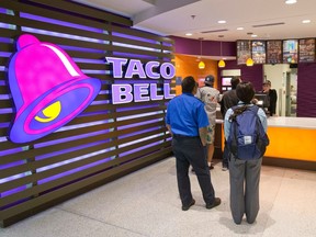 FILE- In this Oct. 17, 2017, file photo, customers line up at a Taco Bell restaurant inside Miami International Airport in Miami. Yum Brands, Inc., which operates Taco Bell, KFC and Pizza Hut, reports earnings Wednesday, May 2, 2018.