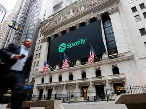 FILE- In this April 3, 2018, file photo, a Spotify banner adorns the facade of the New York Stock Exchange. Spotify reports earnings Wednesday, May 2.