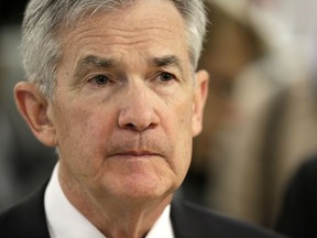 FILE- In this April 6, 2018, file photo, Federal Reserve Chairman Jerome Powell listens as he tours mHUB during a visit to Chicago. The Federal Reserve releases minutes from its most recent policymakers' meeting on Wednesday, May 23.