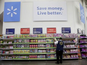 FILE- In this Nov. 9, 2017, file photo, a Walmart employee scans items while conducting an exercise during a Walmart Academy class session at the store in North Bergen, N.J. Walmart is offering its employees a new perk: affordable access to a college degree. America's largest private employer, which in the past has helped its workers get their high school or equivalency degree, hopes the new benefit will help it recruit and retain higher quality entry-level employees in a tight U.S. labor market.