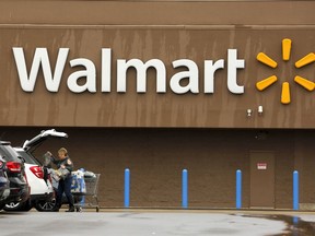 FILE- In this Feb. 22, 2018, file photo, a shopper loads her car after shopping at a Walmart in Pittsburgh. Walmart Inc. reports earnings on Thursday, May 17, 2018.