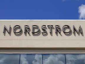FILE- In this Aug. 23, 2017, file photo, a Nordstrom sign is displayed outside of a mall in Indianapolis. Nordstrom Inc. reports earnings on Thursday, May 17, 2018.
