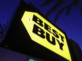 FILE- In this May 23, 2017, file photo, a Best Buy store sign is illuminated, in Orange, Calif. Best Buy Co. Inc. reports earnings on Thursday, May 24, 2018.