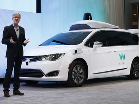 FILE - In this Sunday, Jan. 8, 2017, file photo, John Krafcik, CEO of Waymo, the autonomous vehicle company created by Google's parent company, Alphabet, introduces a Chrysler Pacifica hybrid outfitted with Waymo's own suite of sensors and radar, at the North American International Auto Show in Detroit. A self-driving car service that Google spinoff Waymo plans to launch later this year in Arizona will include up to 62,000 Chrysler Pacifica Hybrid minivans under a deal announced Thursday, May 31, 2018.