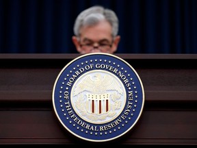 FILE- In this March 21, 2018, file photo, Federal Reserve Chairman Jerome Powell looks to his notes as he speaks during a news conference following the Federal Open Market Committee meeting in Washington.  As the government drives to loosen restraints on banks, the Federal Reserve is set to ease a rule aimed at defusing the kind of risk-taking on Wall Street that helped trigger the 2008 financial meltdown.