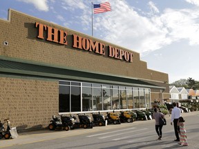 FILE - In this May 18, 2016, file photo, people approach an entrance to a Home Depot store in Bellingham, Mass. Wall Street expects another strong quarterly report card from Home Depot. Financial analysts predict the home-improvement retailer will report Tuesday, May 15, 2018, that its fiscal first-quarter results improved from a year earlier. That would be in line with Home Depot's results in the 12 months that ended in January. The company has benefited as more people invest in home remodeling amid a strong housing market.