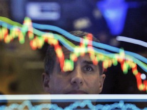 FILE- In this April 19, 2017, file photo, specialist Anthony Rinaldi is reflected in a screen at his post on the floor of the New York Stock Exchange. The U.S. stock market opens at 9:30 a.m. EDT on Tuesday, May 15, 2018.