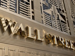 FILE- In this April 24, 2018, file photo, a sign for a Wall Street building is shown in New York. The U.S. stock market opens at 9:30 a.m. EDT on Wednesday, May 30.