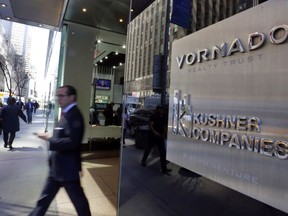 FILE - In this Wednesday, March 29, 2017, file photo, a man walks out of the 666 Fifth Avenue office tower in New York. The company owned by the family of Jared Kushner is in talks to sell a stake in its struggling Fifth Avenue skyscraper to a real estate fund. Jared Kushner, President Donald Trump's son-in-law, bought the skyscraper for a record $1.8 billion more than a decade ago when he was CEO of his family's company, and the office building has been losing money ever since.