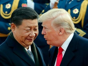 FILE - In this Nov. 9, 2017, file photo, U.S. President Donald Trump, right, chats with Chinese President Xi Jinping during a welcome ceremony at the Great Hall of the People in Beijing. Critics fear foreign government favors to Trump businesses have become business as usual. Ethics watchdogs say apparent quid-pro-quo deals are not being stopped by a Republican-led Congress or the courts.