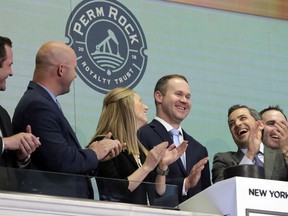 Boaz Energy II CEO Marshall Eves, third from right, is applauded as he rings the New York Stock Exchange's opening bell, Wednesday, May 2, 2018, to mark the IPO of PermRock Royalty Trust.