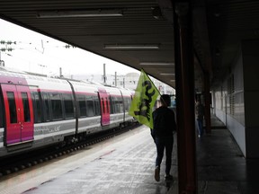 A unionist walks a the platform at the Gare du Nord train station in Paris, Monday, May 14, 2018. French rail unions stepped up their strike action on Monday, the 18th day of the ongoing action, which left rail services severely disrupted around the country.