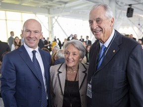 Laurent Beaudoin, right, chairman emeritus of Bombardier Inc., and his wife Claire pause for a photo with company president and CEO Alain Bellemare prior to the company's annual meeting Thursday, May 3, 2018 in Montreal.
