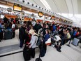 Passengers line up to check in at Toronto Pearson International Airport.