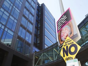 In this photo taken on May 17, 2018, an anti-abortion poster is hung on a lamppost outside the Google offices in Dublin, Ireland. In homes and pubs, on leaflets and lampposts, debate rages in Ireland over whether to lift the country's decades-old ban on abortion. Pro-repeal banners declare: "Her choice: vote yes." Anti-abortion placards warn against a "license to kill." Online, the argument is just as charged _ and more shadowy _ as unregulated ads of uncertain origin battle to sway voters ahead of Friday's referendum, which could give Irish women the right to end their pregnancies for the first time. The emotive campaign took a twist this month when Facebook and Google look last-minute decisions to restrict or remove ads relating to the abortion vote. It is the latest response to global concern about social media's role in influencing political campaigns for the U.S. presidency and Brexit.