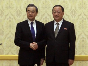 North Korean Foreign Minister Ri Yong Ho, right, poses with Chinese Foreign Minister Wang Yi at the Mansudae Assembly Hall in Pyongyang, North Korea Wednesday, May 2, 2018.