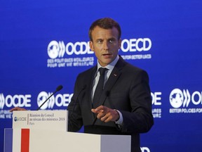 French President Emmanuel Macron delivers a speech at the OECD ministerial council meeting on "Refounding Multilateralism" in Paris, France, Wednesday, May 30, 2018. Macron warned against trade wars in an impassioned speech about international cooperation Wednesday, two days before the Trump administration decides whether to hit Europe with punishing new tariffs.