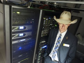 In this March 8, 2018 photo Wyoming state Rep. Tyler Lindholm poses next to computer servers in an office building in Cheyenne, Wyo. Lindholm was a lead proponent of several new laws that have made Wyoming friendly to the networked ledgering technology called blockchain. Supporters say that by welcoming blockchain, the technology underlying cryptocurrencies including bitcoin, Wyoming has become a good place for tech business.