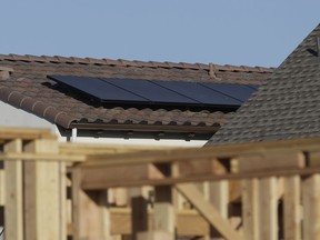 In this photo taken Monday, May 7, 2018, solar panels are seen on the rooftop on a home in a new housing project in Sacramento, Calif. The California Energy Commission will take up a proposal, Wednesday, May 9, 2018 , to require solar panels on new residential homes and low-rise apartment buildings up to three starting in 2020.