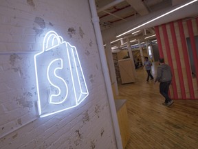 The logo of Shopify Inc. hangs on a wall at the company's office space in Toronto, Ontario, Canada.