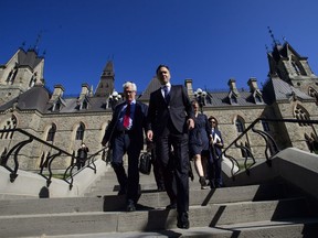 Natural Resources Minister James Carr and Finance Minister Bill Morneau leave a cabinet meeting on route to the National Press Theatre in Ottawa on Tuesday, May 29, 2018. Finance Minister Bill Morneau says Canada is going to buy the Trans Mountain pipeline and all of Kinder Morgan Canada's core assets for $4.5 billion.