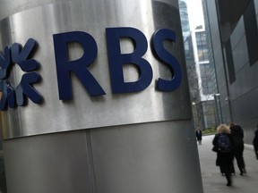 FILE - This is a Thursday, Jan. 26, 2017 file photo of People as they walk past one of the headquarters buildings showing the logo of the Royal Bank of Scotland in London. Royal Bank of Scotland said Thursday May 10, 2018 it has agreed to pay $4.9 billion to settle U.S. claims that it misled investors who bought securities backed by risky mortgages in the run up to the 2008 financial crisis.