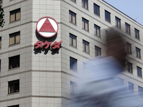 This April 20, 2018 photo, shows head office of Japanese drugmaker Takeda in Tokyo. Takeda has agreed to buy Shire Plc for 46 billion pounds ($62.4 billion) in cash and stock, one of the biggest deals ever in the pharmaceuticals industry, the companies said in statements Tuesday, May 8, 2018.
