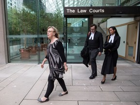 Green Party Leader Elizabeth May, left, and her lawyers Alexander Ejsmony, centre, and Andi Mackay leave B.C. Supreme Court in Vancouver, on Monday May 28, 2018, after May pleaded guilty to a criminal contempt of court charge for violating an injunction at a Kinder Morgan work site. May, who was arrested in March at a Trans Mountain pipeline terminal in Burnaby when she joined activists, was ordered by a judge to pay a $1,500 fine.